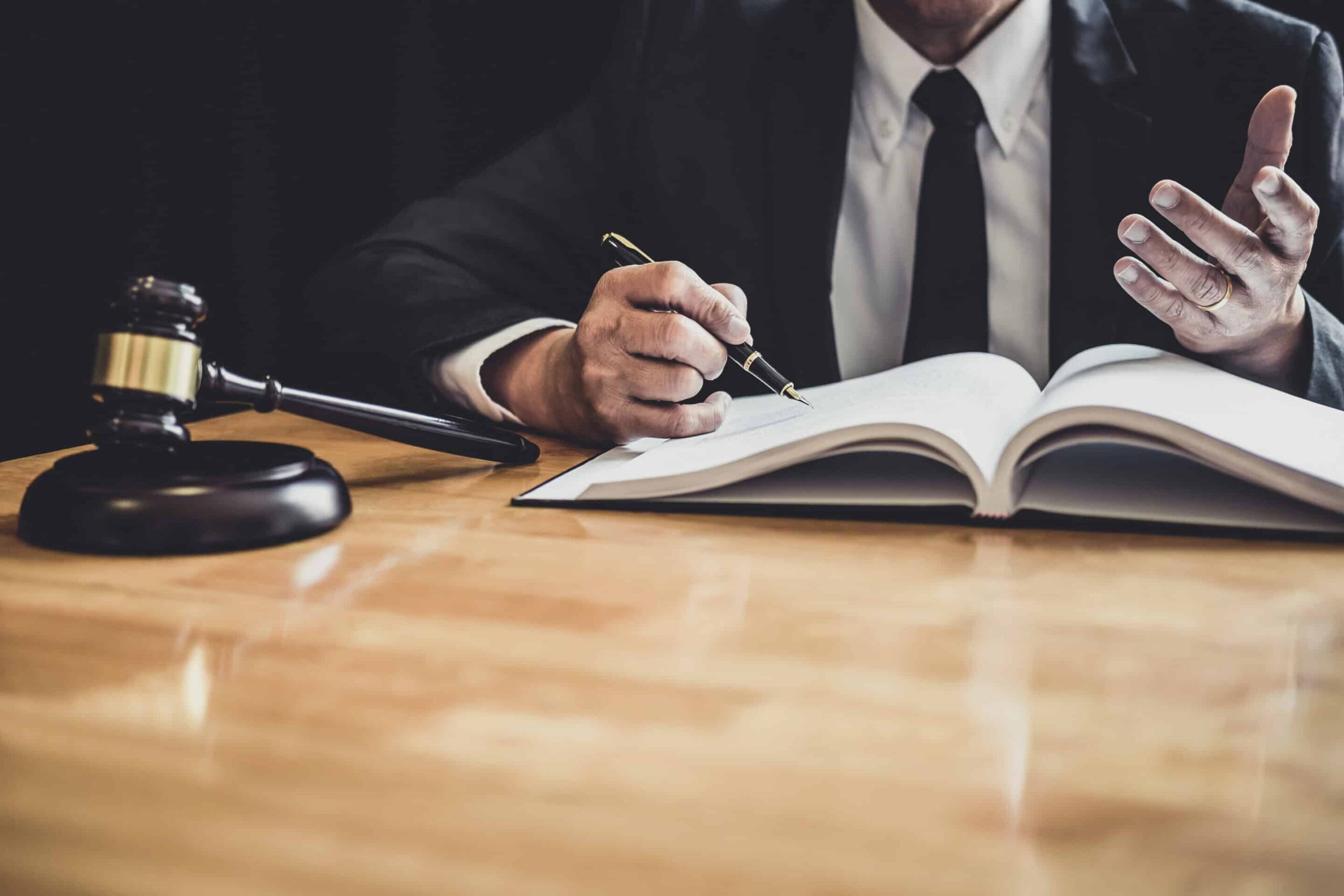 Male,Lawyer,Or,Judge,Working,With,Contract,Papers,,Law,Books